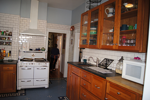 Victorian kitchen with walls lined with subway tile.